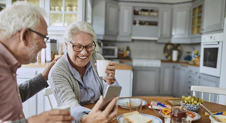 Couple laughing at something on the phone